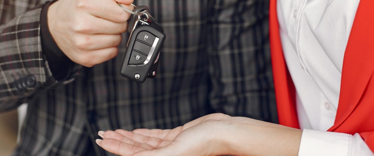 Couple in a car salon. Family buying the car. Elegant woman with her boyfriend.